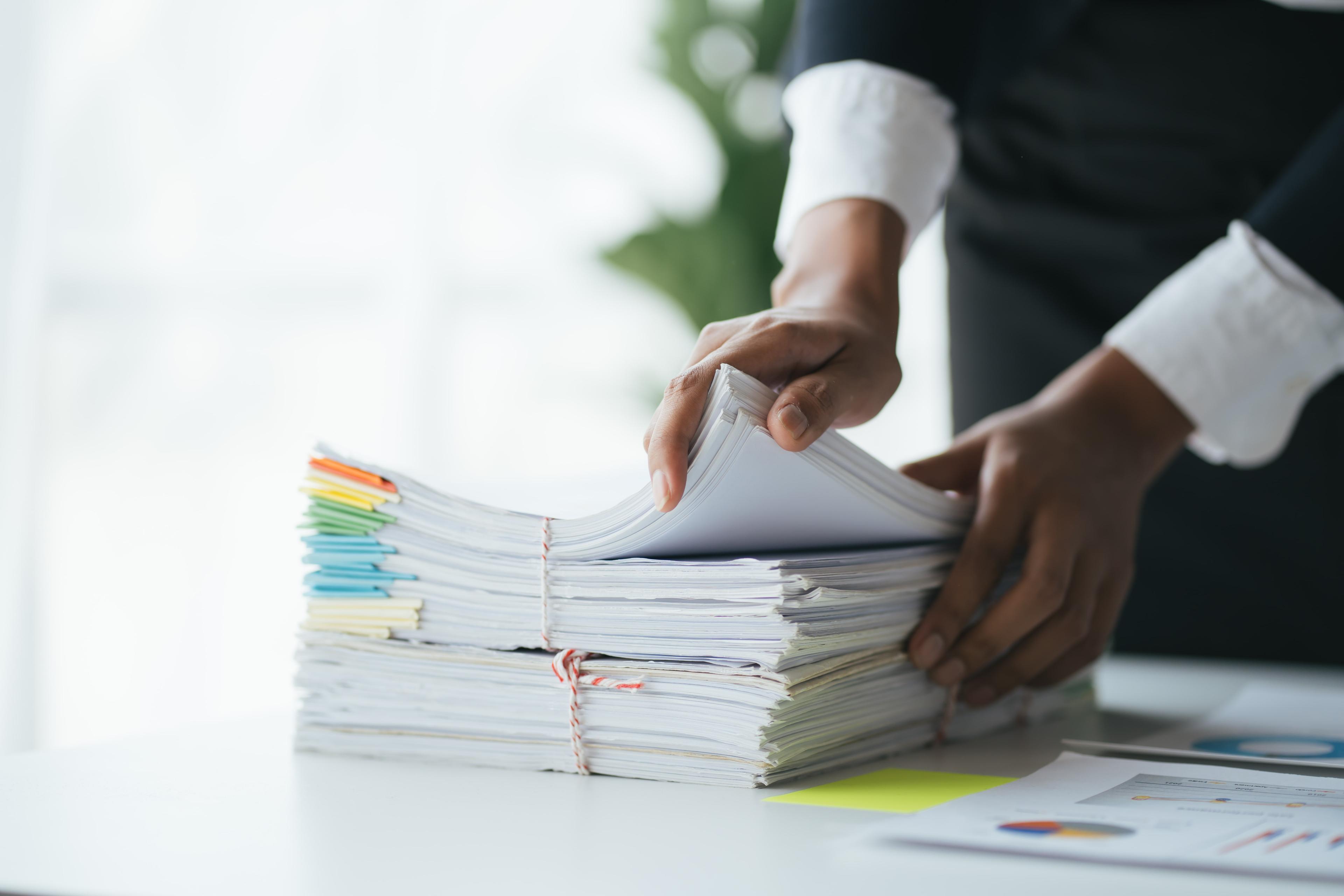 Hands holding a stack of solar installation quotes