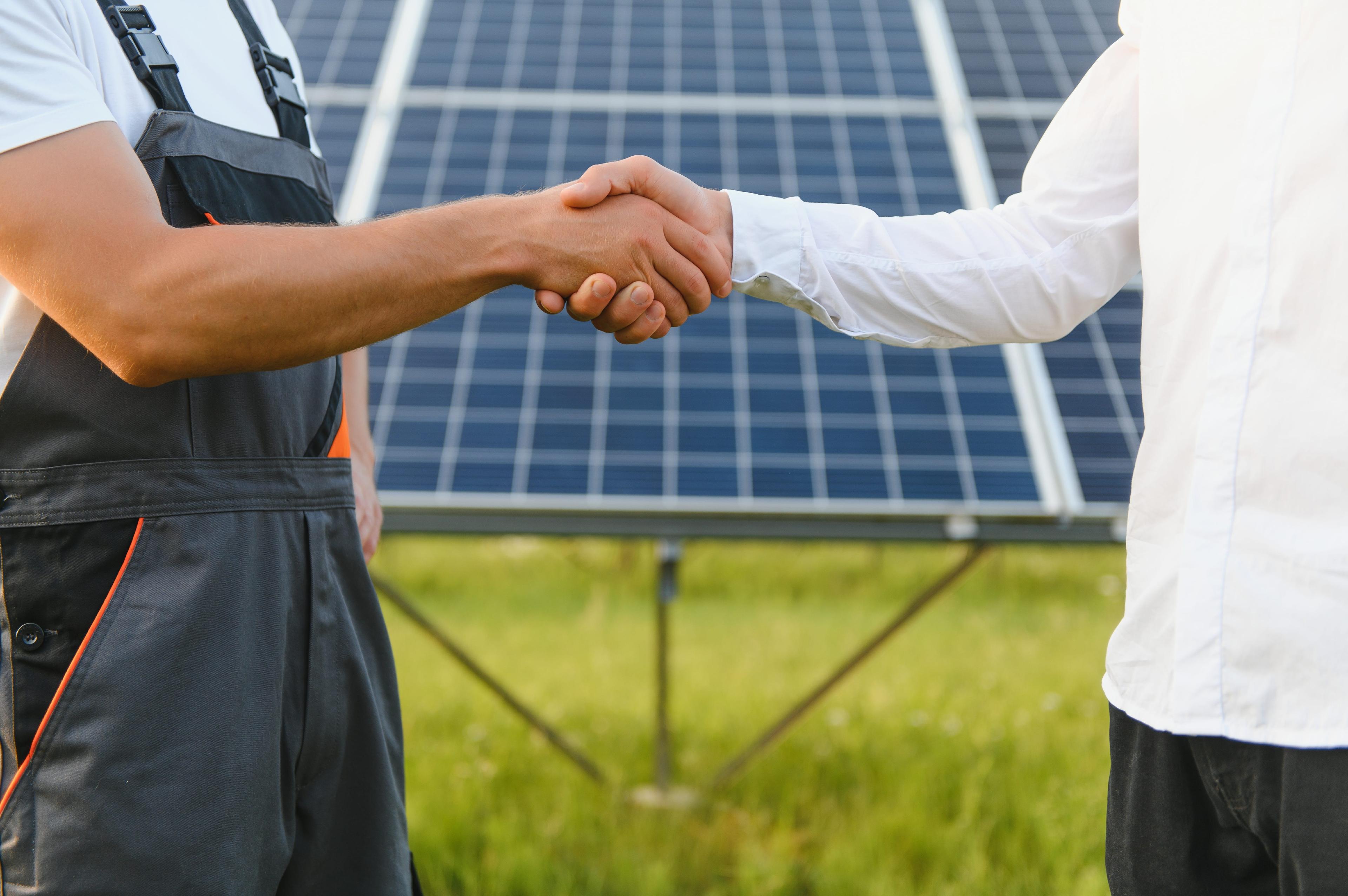 solar installer and client shaking hands